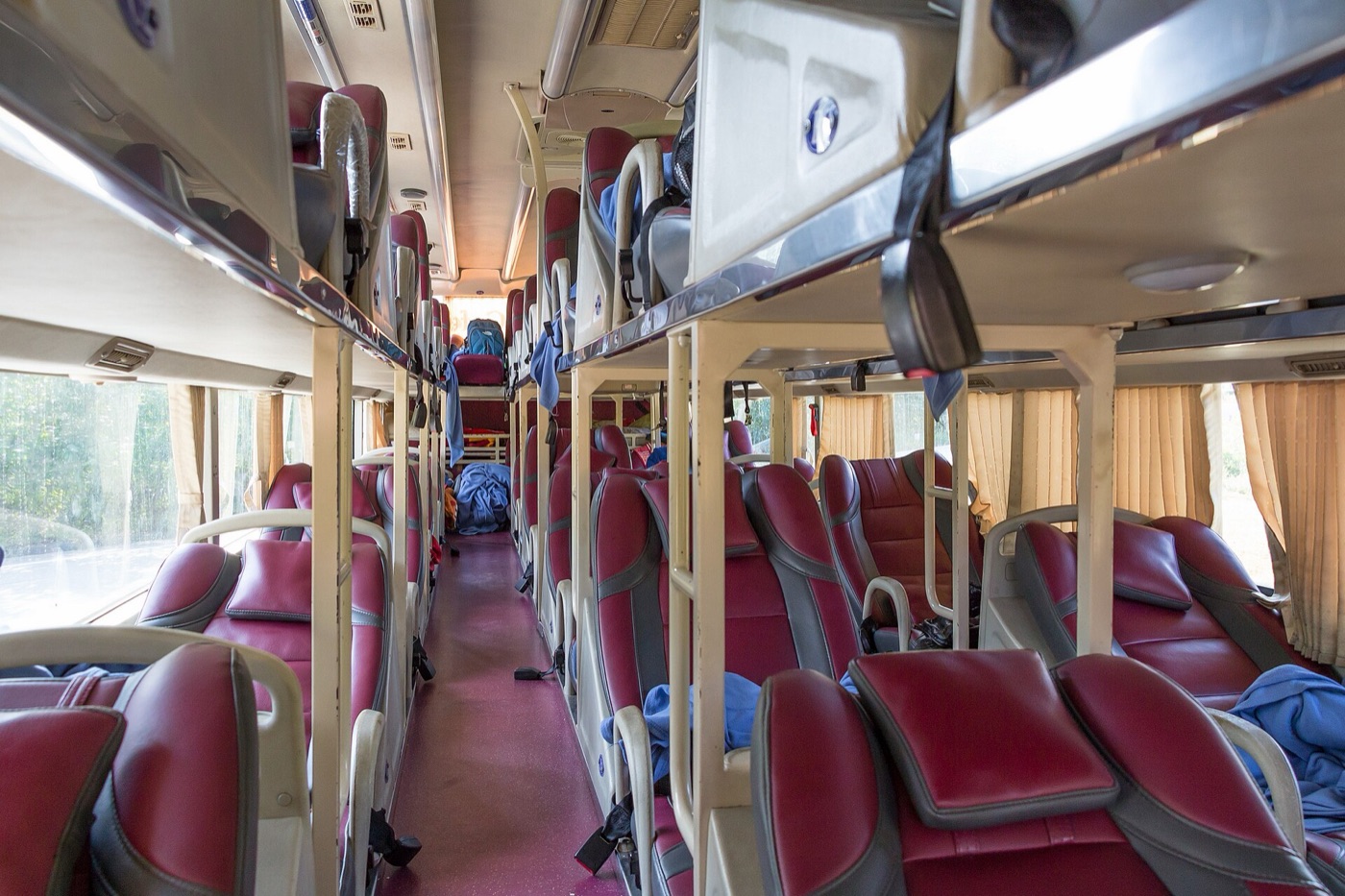 Interior of an AC sleeper coach showing upper and lower berths
